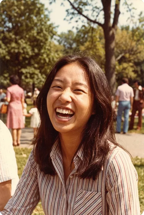 An old film print with a park crowd blurred in the background
